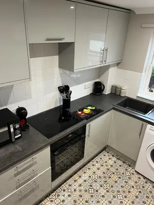a kitchen with a sink and a stove top oven at Charming 1-Bedroom Flat - Chelmsford City Centre in Chelmsford