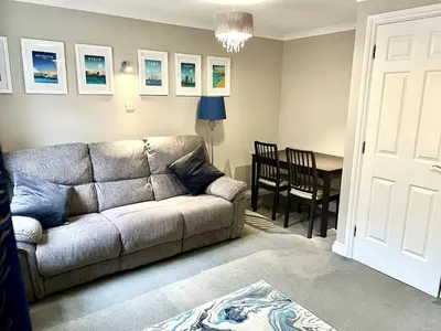a living room with a couch and a table at Charming 1-Bedroom Flat - Chelmsford City Centre in Chelmsford