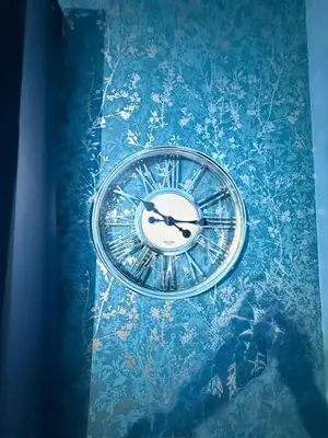 a clock sitting on top of a blue table at The Aqua Stay By Cambridge City Centre in Chesterton
