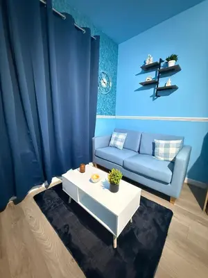 a living room with a couch and a table at The Aqua Stay By Cambridge City Centre in Chesterton