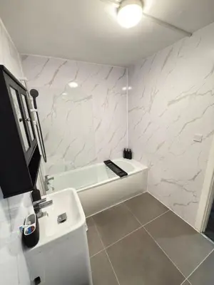 a white bathroom with a tub and a sink at Quiet Blue Rooms By Cambridge City Centre in Chesterton