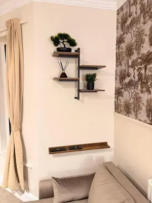 a living room with shelves and a couch at The Coral Stay By Cambridge Central Station in Cambridge