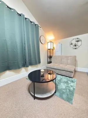 a living room with a couch and a table at The Modern Nest By Cambridge Central Station in Cambridge