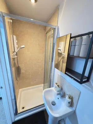 a bathroom with a shower and a sink at The Traveller's Nest by Cambridge Central Station in Cambridge