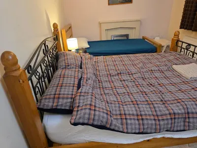 a bedroom with a bed with a plaid blanket at Colchester Hythe home in Hythe