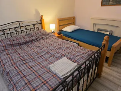 a bedroom with a bed with a blue comforter at Colchester Hythe home in Hythe
