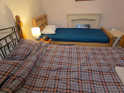 a bedroom with a bed with a plaid blanket at Colchester Hythe home in Hythe