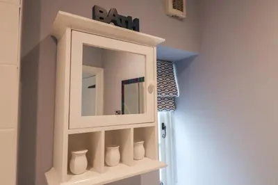 a bathroom with a medicine cabinet with a mirror at The Nutshell in Aldeburgh
