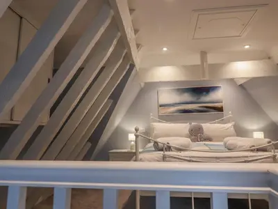 a room with a bed in a attic at The Nutshell in Aldeburgh