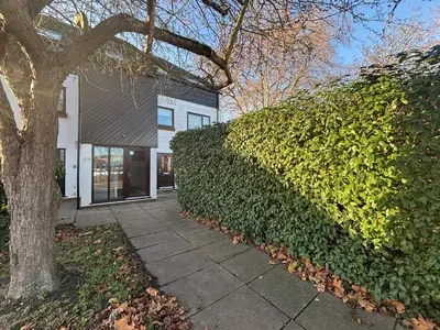 a large green hedge in front of a building at Canal Side Retreat in Maldon