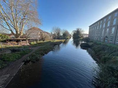 a river in a city with a building next to it at Canal Side Retreat in Maldon