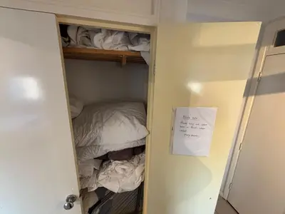 a closet with a bed and a sign on the door at Canal Side Retreat in Maldon