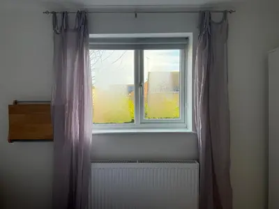a window with a radiator in a room at Entire House with Garden and Office in Milton