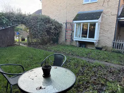 a table with a cup on it in a yard at Entire House with Garden and Office in Milton
