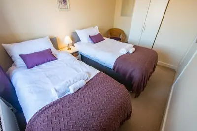two beds sitting next to each other in a room at Serene Sands in Felixstowe