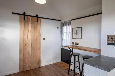 a room with a sliding door and a bar at The Acorn - Roudham Norwich in Norwich