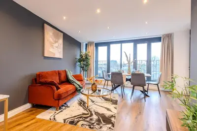 a living room with a couch and a table at Lux 2 Bedroom Flt at Brentwood in Brentwood