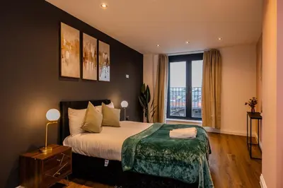 a bedroom with a large bed and a large window at Lux 2 Bedroom Flt at Brentwood in Brentwood