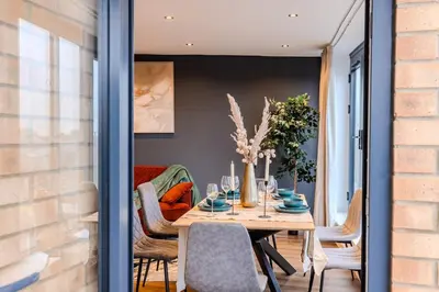 a dining room with a table and chairs at Lux 2 Bedroom Flt at Brentwood in Brentwood