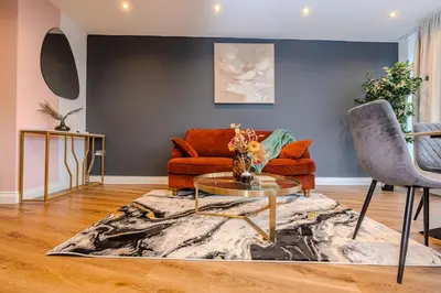 a living room with a couch and a table at Lux 2 Bedroom Flt at Brentwood in Brentwood
