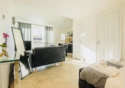 a bedroom with a bed and a desk and a mirror at Riverlight Studio sleep 3 in Cambridge