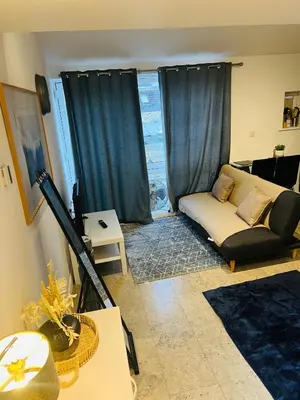 a living room with a couch and a table at Riverlight Studio sleep 3 in Cambridge