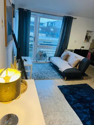 a living room with a couch and a large window at Riverlight Studio sleep 3 in Cambridge