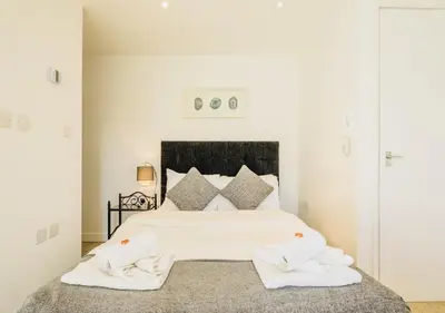 a bedroom with a white bed with two towels on it at Riverlight Studio sleep 3 in Cambridge