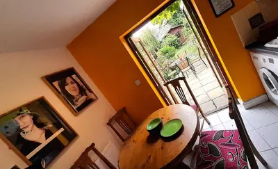 a dining room with a table and a window at Lovely artist's home ecently refurbished in CBG
