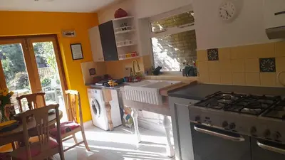 a kitchen with a sink and a stove top oven at Lovely artist's home ecently refurbished in CBG