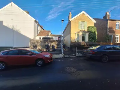 two cars parked in front of a house at Room in Stowmarket in Stowmarket