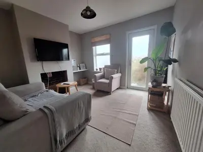 a living room with a couch and a tv at Room in Stowmarket in Stowmarket