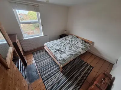 a bedroom with a bed in a room with a window at Room in Stowmarket in Stowmarket