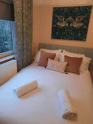 a large white bed with two towels on it at The Grantchester - Charming 20th Century Home in Barton