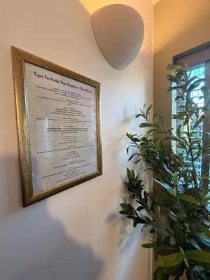a picture hanging on a wall with a plant at The Grantchester - Charming 20th Century Home in Barton