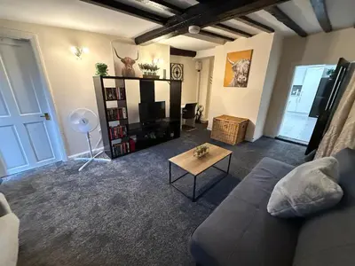 a living room with a couch and a tv at Comfort zone in Colchester