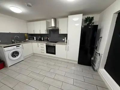 a kitchen with a black refrigerator and a dishwasher at Comfort zone in Colchester