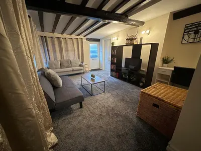 a living room with a couch and a tv at Comfort zone in Colchester