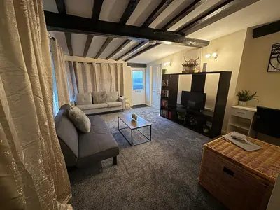 a living room with a couch and a tv at Comfort zone in Colchester