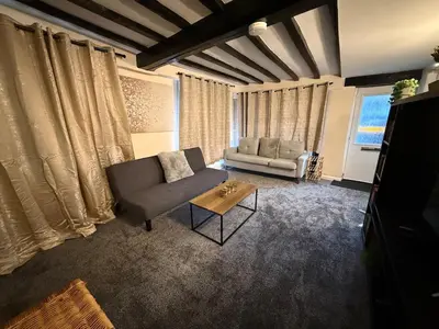 a living room with a couch and a table at Comfort zone in Colchester