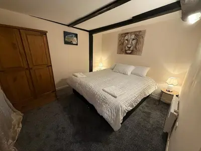 a bedroom with a bed and a wooden door at Comfort zone in Colchester