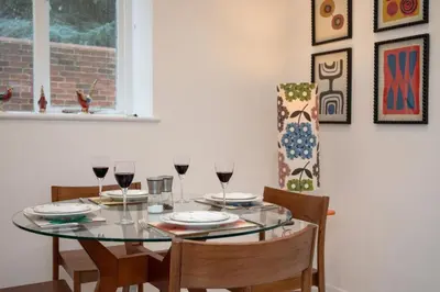 a dining room with a glass table with wine glasses at 2 Bed in Scole oc-p34354 in Scole