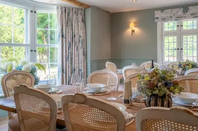 a dining room with a table and chairs and windows at 11 Bed in Stebbing oc-p34450 in Stebbing