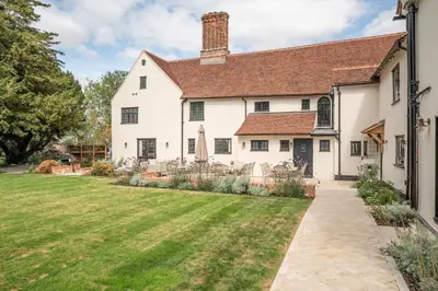 an exterior view of a white house with a yard at 11 Bed in Stebbing oc-p34450 in Stebbing