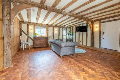 a living room with a couch and a television at 11 Bed in Stebbing oc-p34450 in Stebbing