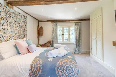a bedroom with a large bed with towels on it at 11 Bed in Stebbing oc-p34450 in Stebbing