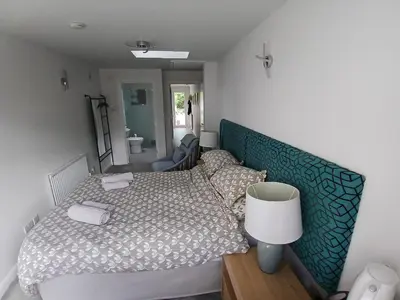 a small bedroom with a bed and a mirror at Ensuite Room with Private Entrance in St Ives
