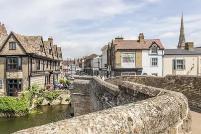 a bridge over a river in a town with buildings at Ensuite Room with Private Entrance in St Ives
