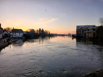 a view of a river at sunset with houses at Ensuite Room with Private Entrance in St Ives