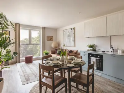 a kitchen and living room with a table and chairs at Charles Hope Cambridge in Cambridge